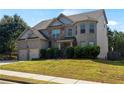 A charming two-story home with a brick facade, well-maintained lawn, and beautiful curb appeal at 5253 Rosewood Pl, Fairburn, GA 30213