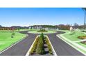 Scenic roundabout street view of a new construction home community with lush greenery and well-maintained landscaping at 8603 Secretariat Dr, Lithonia, GA 30058