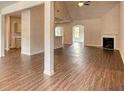 Open-concept living room with vaulted ceilings, fireplace, and hardwood floors at 911 Park Place St, Social Circle, GA 30025