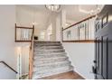 A grand staircase at the front entrance, featuring wood and white railings and a high ceiling at 4030 Staghorn Ct, Douglasville, GA 30135