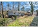 Well-maintained, one-story house with a covered carport and a partially-shaded lawn at 4981 Crowe Se Dr, Smyrna, GA 30082