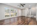 Bright living room featuring hardwood floors, natural light, ceiling fan, and easy access to the upstairs and basement at 4981 Crowe Se Dr, Smyrna, GA 30082