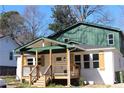 Renovated house with white brick and wood shutters, a covered front porch with new columns, and railings at 1285 Mcclure Nw Ave, Atlanta, GA 30314