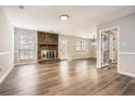Spacious living room featuring hardwood floors and a classic brick fireplace at 1669 Glen Arm Dr, Lithonia, GA 30058