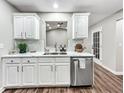 Bright kitchen featuring stainless steel appliances, modern countertops, and wood flooring at 217 Lamb Rd, Moreland, GA 30259