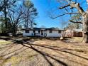 Spacious backyard with mature trees creating natural shade for outdoor enjoyment at 2213 Sandtown Sw Rd, Marietta, GA 30060