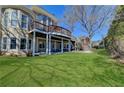 Expansive backyard perfect for entertaining with an elevated deck, a covered patio and lush lawn at 7910 St Marlo Country Club Pkwy, Duluth, GA 30097