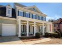 Inviting front porch with classic columns and comfortable seating, perfect for relaxing at 5046 Sara Creek Way, Sugar Hill, GA 30518