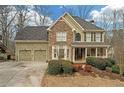 Attractive home showcasing a stone facade, a two-car garage, and a beautifully landscaped front yard at 582 Braidwood Nw Dr, Acworth, GA 30101
