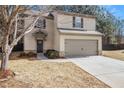Charming two-story home with a gray 2-car garage, dark trimmed windows and a well-manicured lawn at , Fairburn, GA 30213