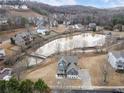 Beautiful aerial view of a home overlooking a pond and surrounding community at 15 Lakeside Way, Cartersville, GA 30121