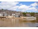 A serene lakeside community with well-maintained homes and a charming white bridge over the water at 15 Lakeside Way, Cartersville, GA 30121