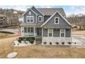 Charming home with a welcoming front porch, decorative stonework, and manicured landscaping at 15 Lakeside Way, Cartersville, GA 30121