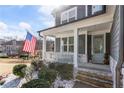 Charming front porch with stone accents, white railings, and a welcoming blue door at 15 Lakeside Way, Cartersville, GA 30121