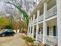 Side view of house showcasing the white-columned porch and landscaping at 1790 Whitley Rd, Dacula, GA 30019