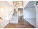 Bright foyer with hardwood flooring and staircase leading to the upper level at 200 Ridge Bluff Ln, Suwanee, GA 30024