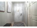 Entryway with neutral paint, bench, and gray patterned rug on tile flooring at 101 Fair Haven Se Way, Smyrna, GA 30080