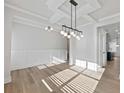 Living room featuring modern light fixtures and white wainscoting at 4024 Hosch Retreat Dr, Buford, GA 30519