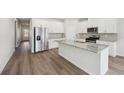Modern kitchen showcases stainless steel appliances, an island, and stylish countertops at 7758 Plymouth Dr, Fairburn, GA 30213