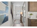 Bright hallway featuring wood floors, staircase, and access to various rooms at 720 Shetland Trl, Cartersville, GA 30121