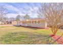 A single-story home with charming curb appeal, landscaped yard, and an attached two-car garage at 1408 Lake Paradise Rd, Villa Rica, GA 30180