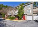 Three-story townhouse complex with neat landscaping and attached garages, creating a well-maintained curb appeal at 2700 Pine Tree Ne Rd # 4006, Atlanta, GA 30324