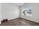 Empty room with wood floors and a window providing natural light at 744 Clark Lake Estates Dr, Grayson, GA 30017