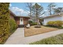 Welcoming brick home exterior with a classic white front door and a well-manicured lawn at 3831 Montford Dr, Atlanta, GA 30341