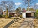 Quaint single-story brick home featuring a covered carport and a traditional, well-kept front yard at 3831 Montford Dr, Atlanta, GA 30341