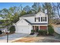Charming two-story home with a well-maintained front yard and attached two-car garage at 455 Registry Blf, Stone Mountain, GA 30087
