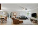 Spacious living room with light-colored floors, a ceiling fan, and abundant natural light at 455 Registry Blf, Stone Mountain, GA 30087