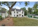 Charming two-story home with a well manicured lawn and inviting curb appeal on a sunny day at 2809 Glenwood Ave, Atlanta, GA 30317