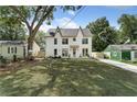 Charming two-story home with a well manicured lawn and inviting curb appeal on a sunny day at 2809 Glenwood Ave, Atlanta, GA 30317