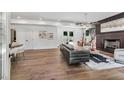 Open-concept living room features hardwood floors, fireplace, and access to an outdoor space at 2809 Glenwood Ave, Atlanta, GA 30317