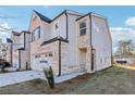 Charming two-story townhome boasts a brick facade, two-car garage and professionally landscaped yard at 552 Pennsy Aly, Mableton, GA 30126