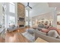 Spacious living room featuring high ceilings, large windows, hardwood floors, and a stone fireplace at 1250 Rosette Way, Marietta, GA 30062
