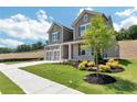 Lovely two-story home with a spacious yard and lush green landscaping at 329 Willow Cv, Canton, GA 30114