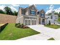 Charming two-story home with two-car garage, beautifully landscaped lawn, and traditional design elements at 329 Willow Cv, Canton, GA 30114