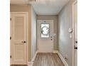 Entryway with a white front door, wood-look floors, and a neutral wall color at 3986 Church View Ln, Suwanee, GA 30024