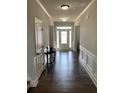 Inviting foyer with hardwood floors, paneled walls, and a bright front door with sidelights at 4241 Summer Breeze Way, Buford, GA 30518