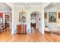 Elegant foyer with hardwood floors, arched doorways, and classic furnishings showcased with refined decor at 8095 Georgetown Cir, Suwanee, GA 30024