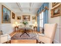 Comfortable living room featuring elegant seating, classic artwork, and a refined rug on beautiful hardwood floors at 8095 Georgetown Cir, Suwanee, GA 30024