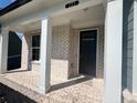 Charming brick front porch with white columns and black door at 223 Willow St, Canton, GA 30114