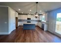 Open concept kitchen with island, stainless steel appliances, and white cabinets at 223 Willow St, Canton, GA 30114