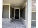 Inviting entryway featuring a brick porch and a stylish black front door, creating a warm welcome at 219 Willow St, Canton, GA 30114