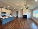 Open-concept living room and kitchen featuring hardwood floors, a fireplace, and ample natural light at 219 Willow St, Canton, GA 30114