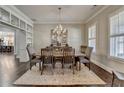 Dining room featuring hardwood floors, a decorative chandelier and a large window at 3905 Alister Park Dr, Cumming, GA 30040