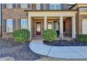 Charming covered front porch with white columns and brick facade at 3905 Alister Park Dr, Cumming, GA 30040