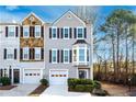Attractive townhome showcases a well maintained yard, single car garage, and neutral exterior at 2021 Pinnacle Pointe Dr, Norcross, GA 30071