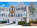 Well-kept townhome with a one-car garage, neutral siding, and a beautifully landscaped front yard at 2021 Pinnacle Pointe Dr, Norcross, GA 30071